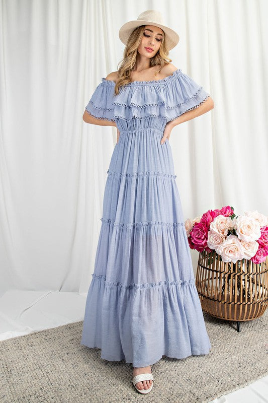Shop this elegant and swingy maxi dress made in an off the shoulder look with tiered ruffle accents.