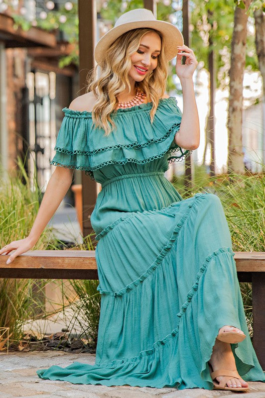 Shop this elegant and swingy maxi dress in green made in an off the shoulder look with tiered ruffle accents.