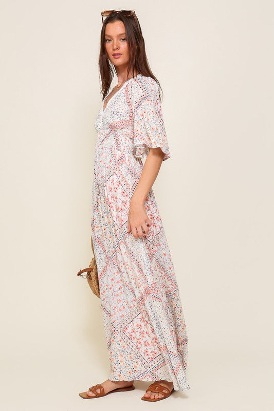 Introducing the Samantha Flowy Short Sleeve Maxi Dress with Self Tie Back Detail. This dress embodies elegance and comfort, featuring a flowy silhouette and charming short sleeves.