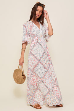 Introducing the Samantha Flowy Short Sleeve Maxi Dress with Self Tie Back Detail. This dress embodies elegance and comfort, featuring a flowy silhouette and charming short sleeves.